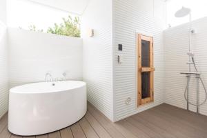 a white bathroom with a sink and a window at Long Vacation Resort in Fukuoka