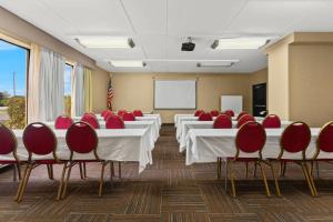 a conference room with white tables and red chairs at Comfort Inn Lehigh Valley West in Fogelsville