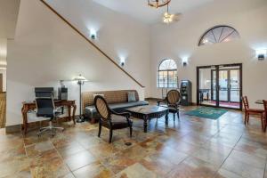 a living room with a couch and chairs and a piano at Quality Inn & Suites South Fork - Wolf Creek in South Fork