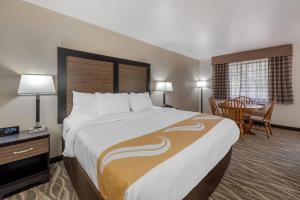 a hotel room with a large bed and a table at Quality Inn & Suites South Fork - Wolf Creek in South Fork +98 photos