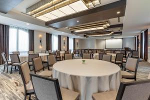 a conference room with a white table and chairs at Cambria Hotel Houston Downtown Convention Center in Houston