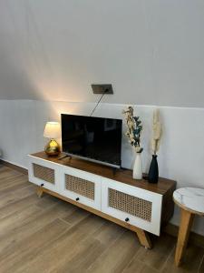 a living room with a flat screen tv on a table at The Alchemist Rishikesh in Birbhaddar