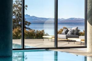 a house with a pool and a view of the water at Radisson Blu Bariloche in San Carlos de Bariloche