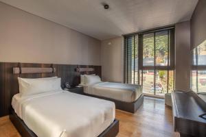 a hotel room with two beds and a window at Radisson Blu Bariloche in San Carlos de Bariloche