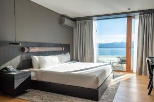 a bedroom with a bed with a view of the ocean at Radisson Blu Bariloche in San Carlos de Bariloche