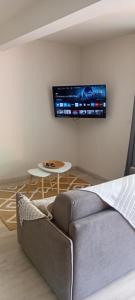a living room with a couch and a table at bambou studio in Les Avirons