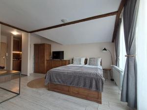 a bedroom with a bed and a large window at Premium StudioApartment in Borovets Gardens in Borovets