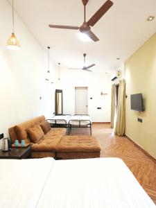 a living room with a couch and a table at Tamarind Retreat in Alibaug
