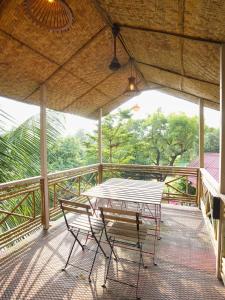 a table and chairs sitting on a deck at Tamarind Retreat in Alibaug