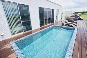 a swimming pool on top of a house at Long Vacation Resort in Fukuoka