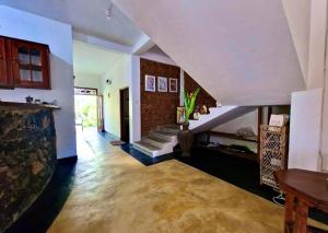 a living room with a staircase and a stair case at Priyanka Villa in Bentota +54 photos