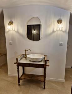 a bathroom with a sink and a mirror at La Cave in Marcigny +6 photos