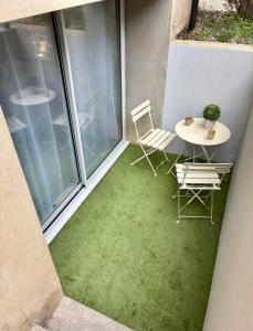 a patio with a table and chairs on a balcony at La Cave in Marcigny