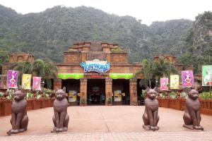 a group of statues of cats in front of a building at EcoPutra Stay in Ipoh