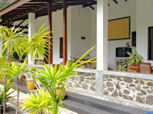 a house with some plants in front of it at Priyanka Villa in Bentota