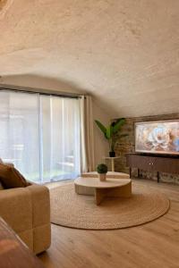a living room with a couch and a table at La Cave in Marcigny