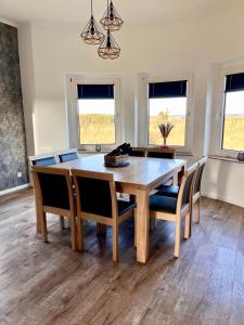 a dining room with a wooden table and chairs at Ferienhaus Zum Brand in Butgenbach