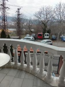 a white railing on a balcony with a parking lot at Кащта за гости АРДА in Kŭrdzhali