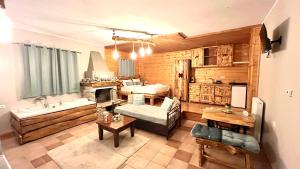a large living room with a couch and a tub at Suites Efharis Filoxenon in Feneos