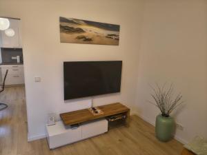 a living room with a flat screen tv on a wall at Ferienwohnung Wiebe in Minden