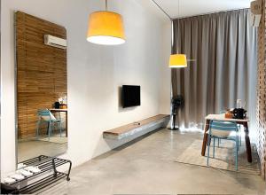 a living room with a television and a table and chairs at Talent Residence in Phnom Penh