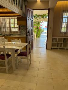 a kitchen and dining room with a table and chairs at Amaryllis Beach House in Lartos