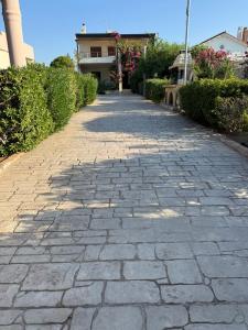 a cobblestone pathway in front of a house at Amaryllis Beach House in Lartos