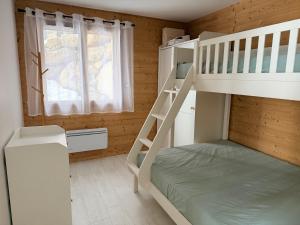 a bedroom with two bunk beds and a window at L'Esquirol Appart - Location T3 avec vue imprenable - Les Angles in Les Angles