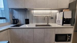 a kitchen with a sink and a microwave at Stay PLAN B in Seoul