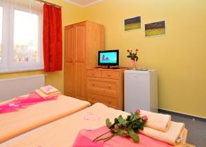 A bed or beds in a room at Apartmany Broma