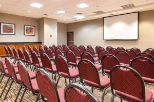 a conference room with red chairs and a screen at Comfort Suites Goodyear-West Phoenix in Goodyear +68 photos