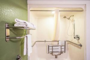 a bathroom with a shower and a mirror at Quality Inn Kansas City International Airport in Kansas City