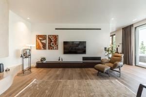 a living room with a couch and a tv at Lake Whisper Villa Pool & Amazing Views by PikHost in Shirokë