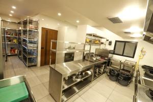 a kitchen with a stainless steel counter and appliances at Fair Stay Hotel in Cochin +37 photos