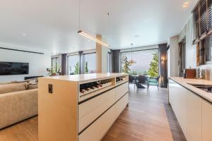 an open kitchen with a couch and a living room at Lake Whisper Villa Pool & Amazing Views by PikHost in Shirokë