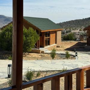 a house with a green roof on top of it at Jabal Hatt Resthouse in Khawr Zammah