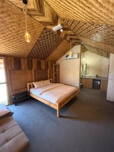 a bedroom with a large bed in a room at Jabal Hatt Resthouse in Khawr Zammah