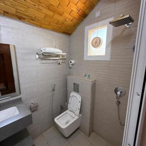 a small bathroom with a toilet and a sink at Jabal Hatt Resthouse in Khawr Zammah +25 photos