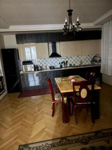 a kitchen with a table and chairs in a room at gaydi in Gori