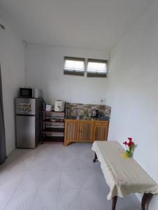 a small kitchen with a table and a stove at Desirella Villa studio in Mahébourg