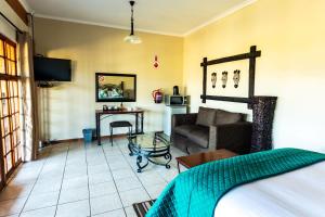 a living room with a couch and a table at Intibane Lodge in Ulundi