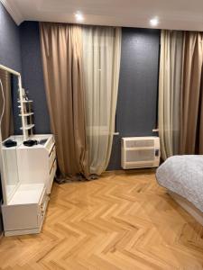 a bedroom with a bed and a wooden floor at gaydi in Gori
