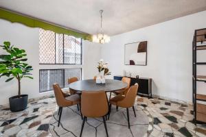 a dining room with a table and chairs at Comfortable House-shared accommodation in Bankstown