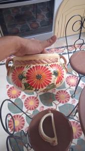 a purse sitting on top of a floor with flowers at Casa Bahareque Merida in Mérida +17 photos