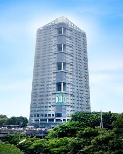 a tall white building with a sign on it at Hotel101 - Fort in Manila