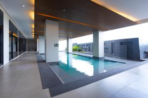 a swimming pool in the middle of a building at Hotel101 - Fort in Manila