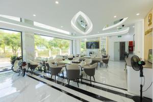 a dining room with tables and chairs in a building at NaCo Hotel in Lao Cai