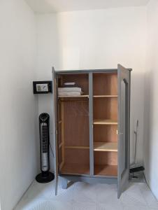 a book shelf in a room with a computer at Desirella Villa studio in Mahébourg
