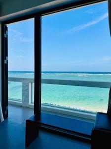 a room with a view of the ocean from a window at Windy Villa Phú Quý in Cù Lao Thu