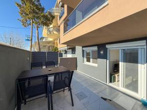a patio with a table and chairs next to a building at MELISSA Suites By SDR in Paralia Katerinis